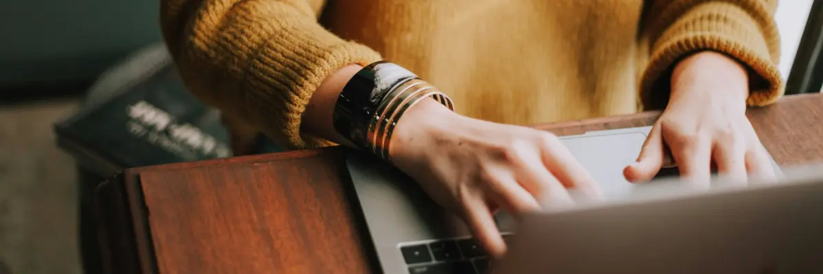 A person typing on a Laptop