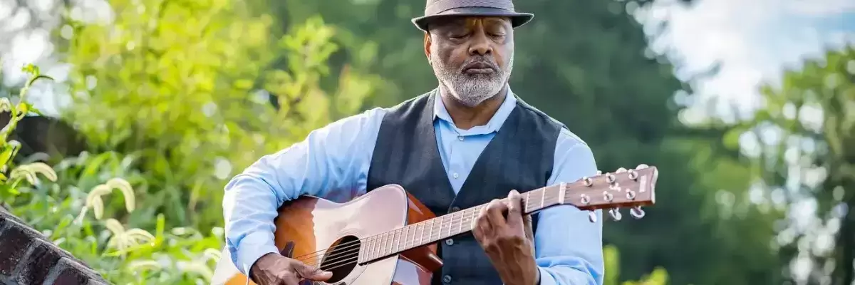 Elderly Man Playing an Acoustic Guitar